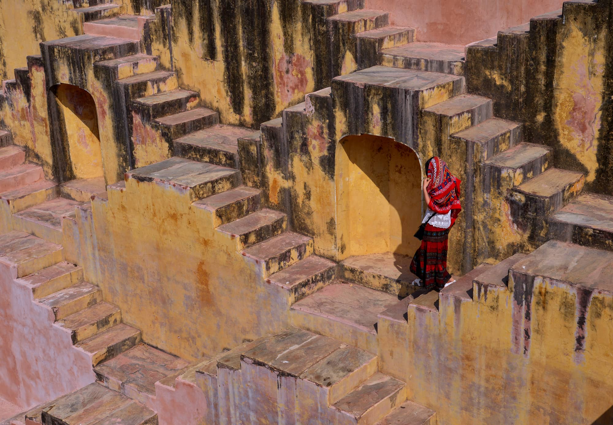 Women in sari walking down stairwell
